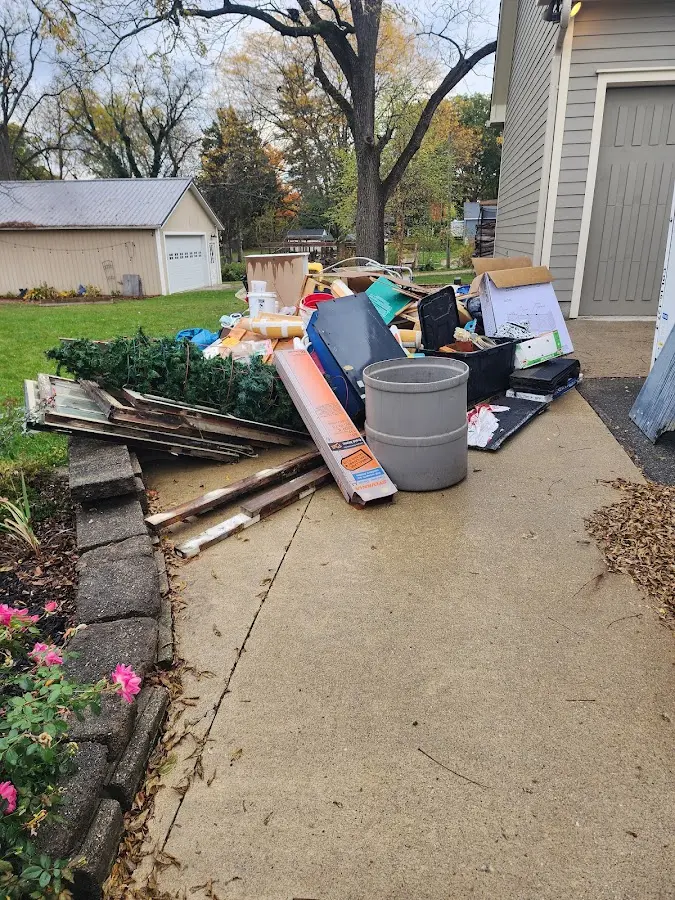 Dumpster being loaded with debris for Roofing Dumpster Rental in Allouez
